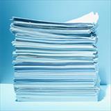 Tall stack of paper with blue background