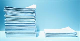 Tall and short stacks of paper with blue background